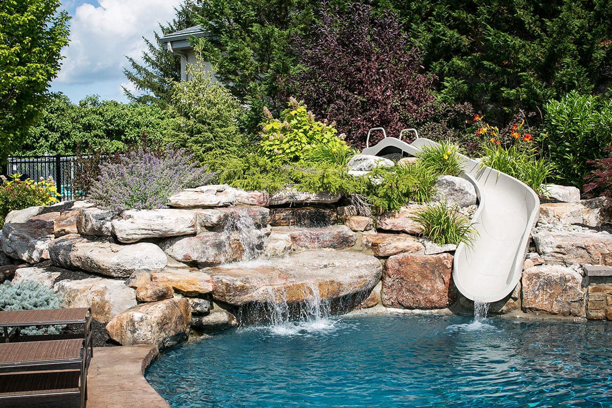 Professional pool excavation with heavy equipment in residential yard